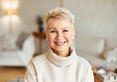  Woman in sweater smiling in living room